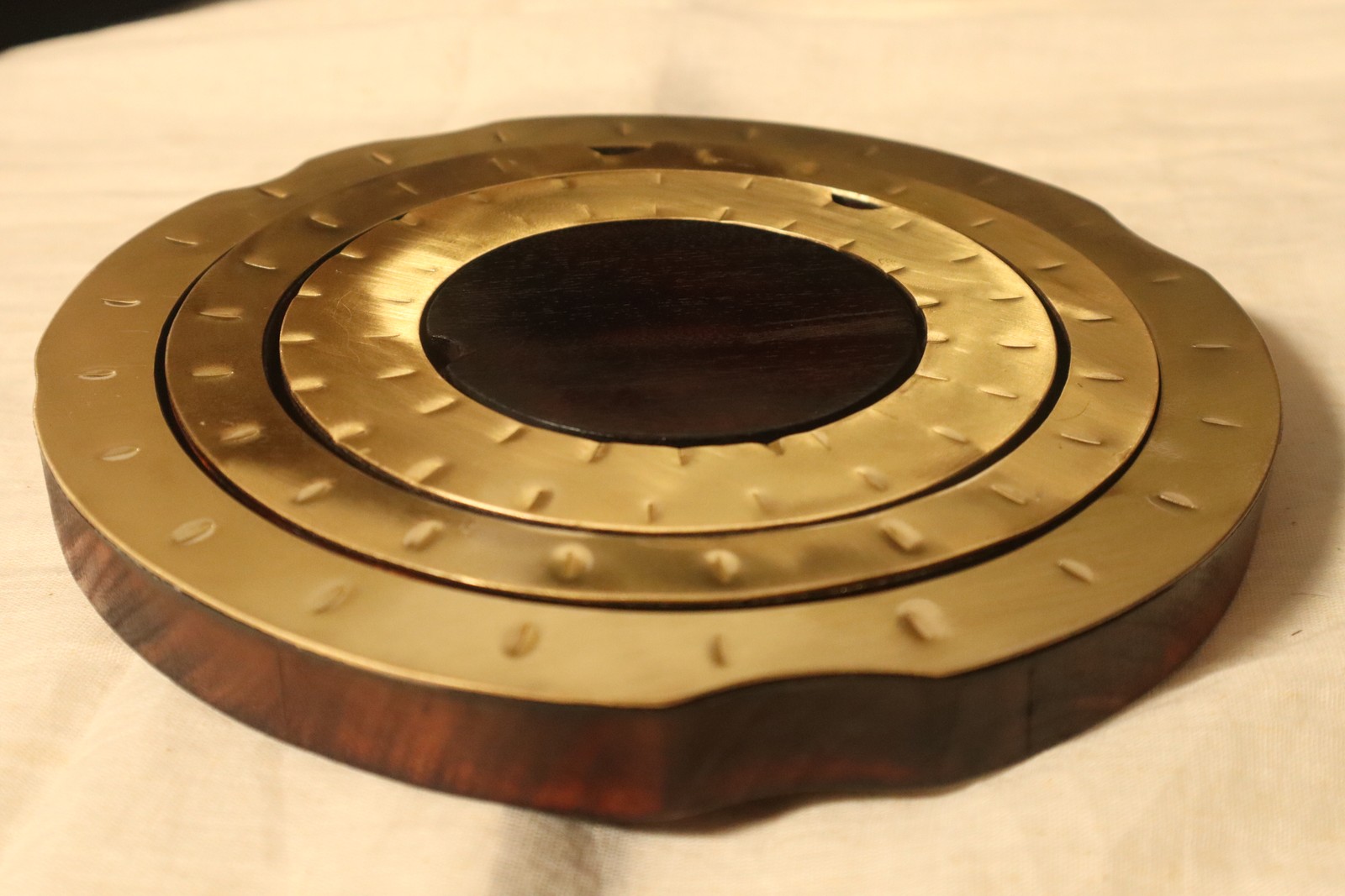 The KOSH set nested together: burnt jackfruit wood with three concentric hand-hammered brass rims