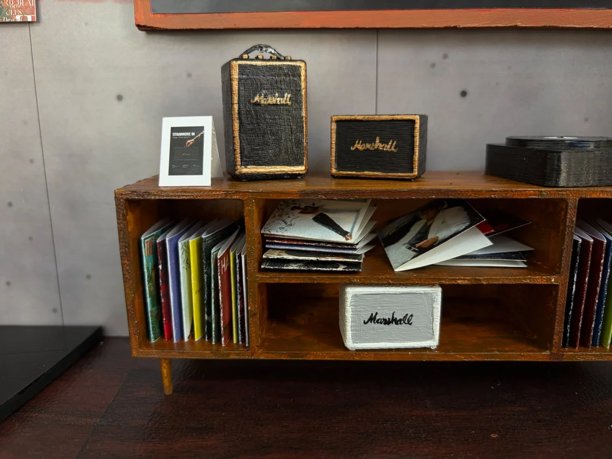Close-up of the model's vinyl console with records and Marshall speakers