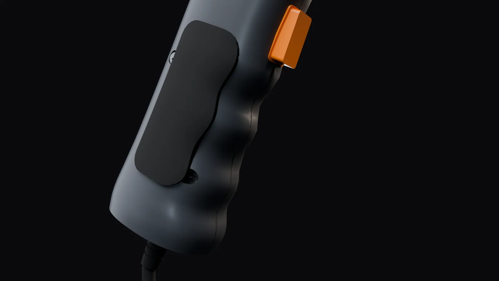 Close-up of the grip: a black finger pad over four soft scallops, the orange trigger at the front